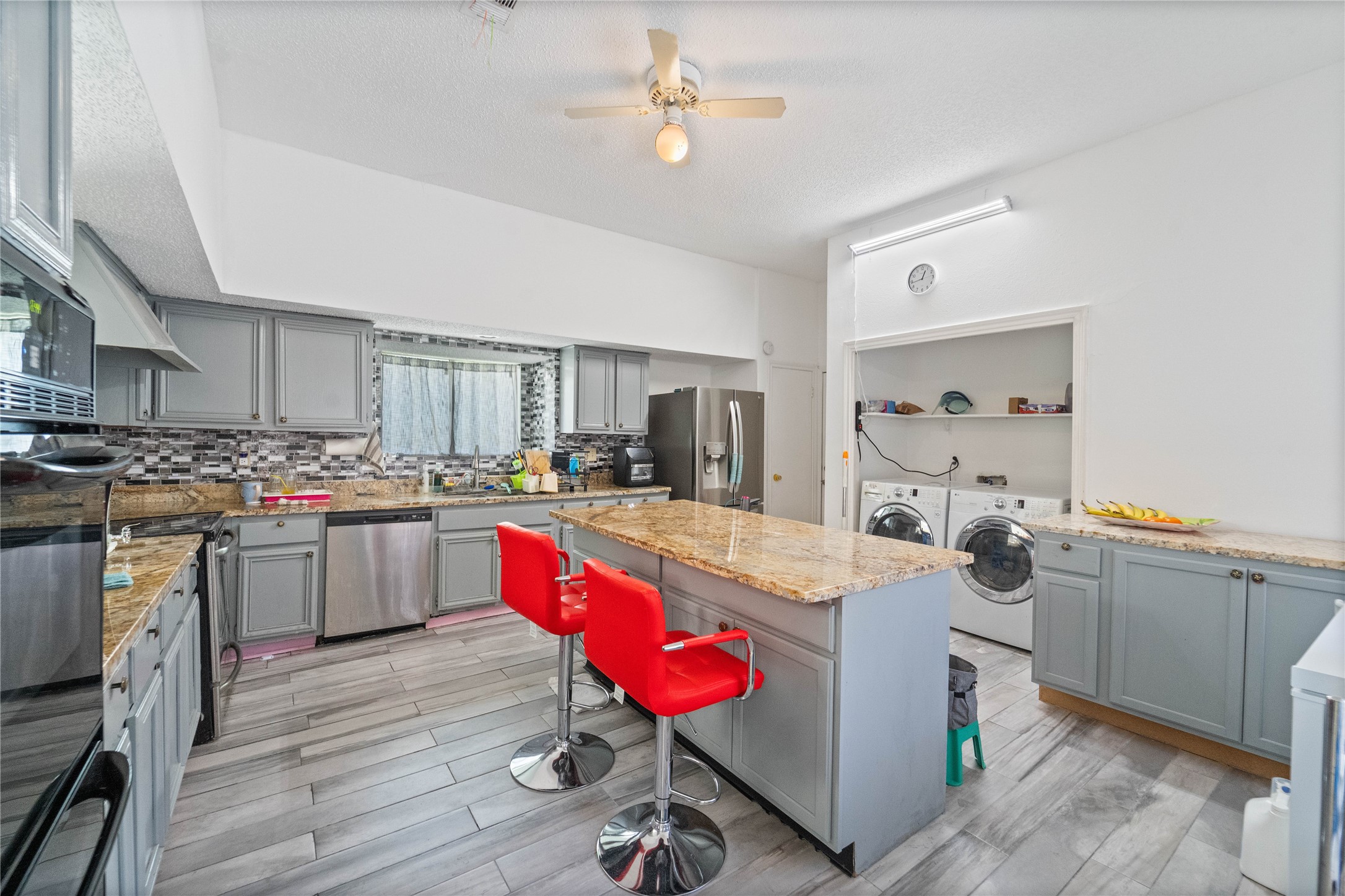 6331 Modesto Drive Houston, TX 77083 - Photo 11 of 31 a kitchen with a refrigerator and wooden cabinets