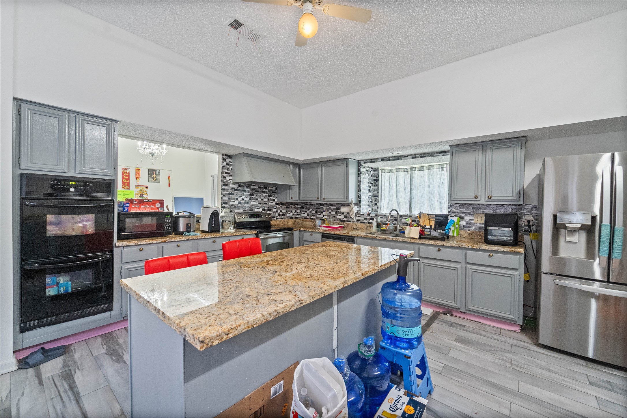 6331 Modesto Drive Houston, TX 77083 - Photo 12 of 31 a kitchen with granite countertop stainless steel appliances and wooden cabinets