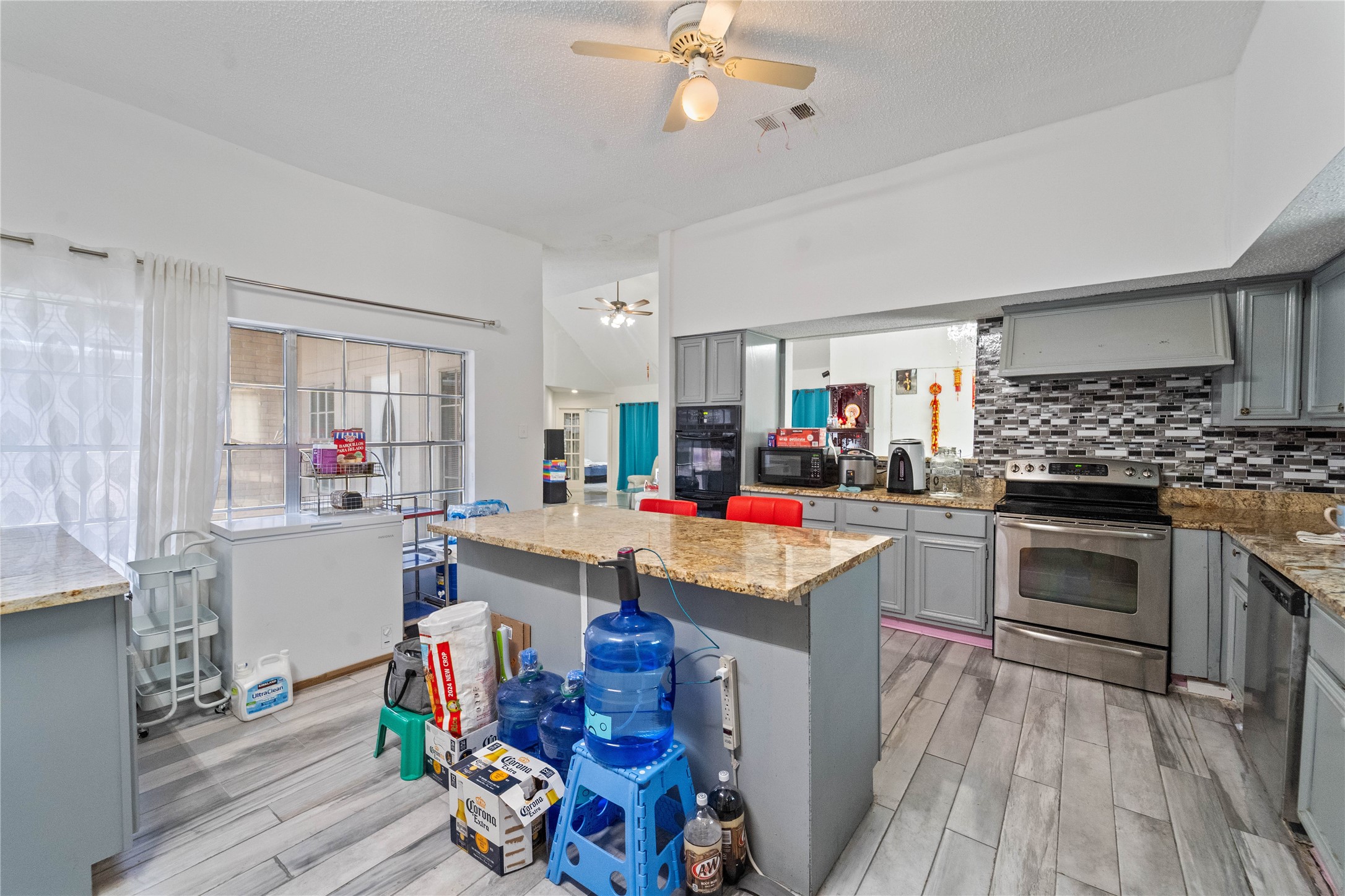 6331 Modesto Drive Houston, TX 77083 - Photo 13 of 31 a open kitchen with stainless steel appliances granite countertop a stove and cabinets