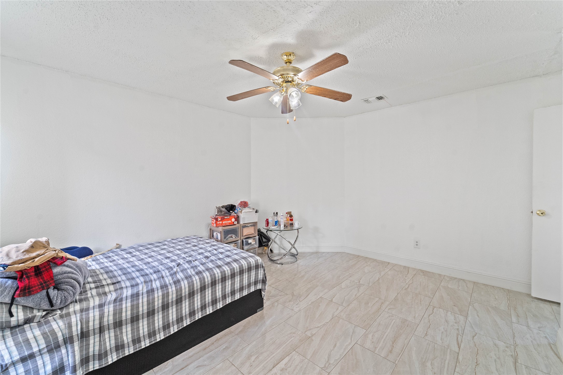 6331 Modesto Drive Houston, TX 77083 - Photo 18 of 31 a bedroom with a bed and a chandelier fan