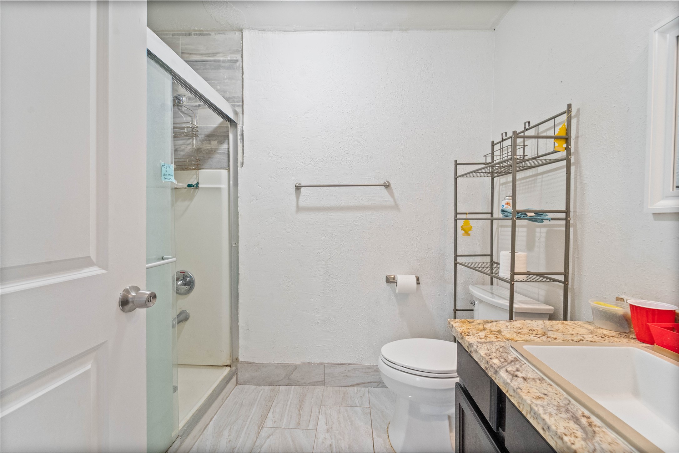 6331 Modesto Drive Houston, TX 77083 - Photo 19 of 31 a bathroom with a sink a toilet and shower
