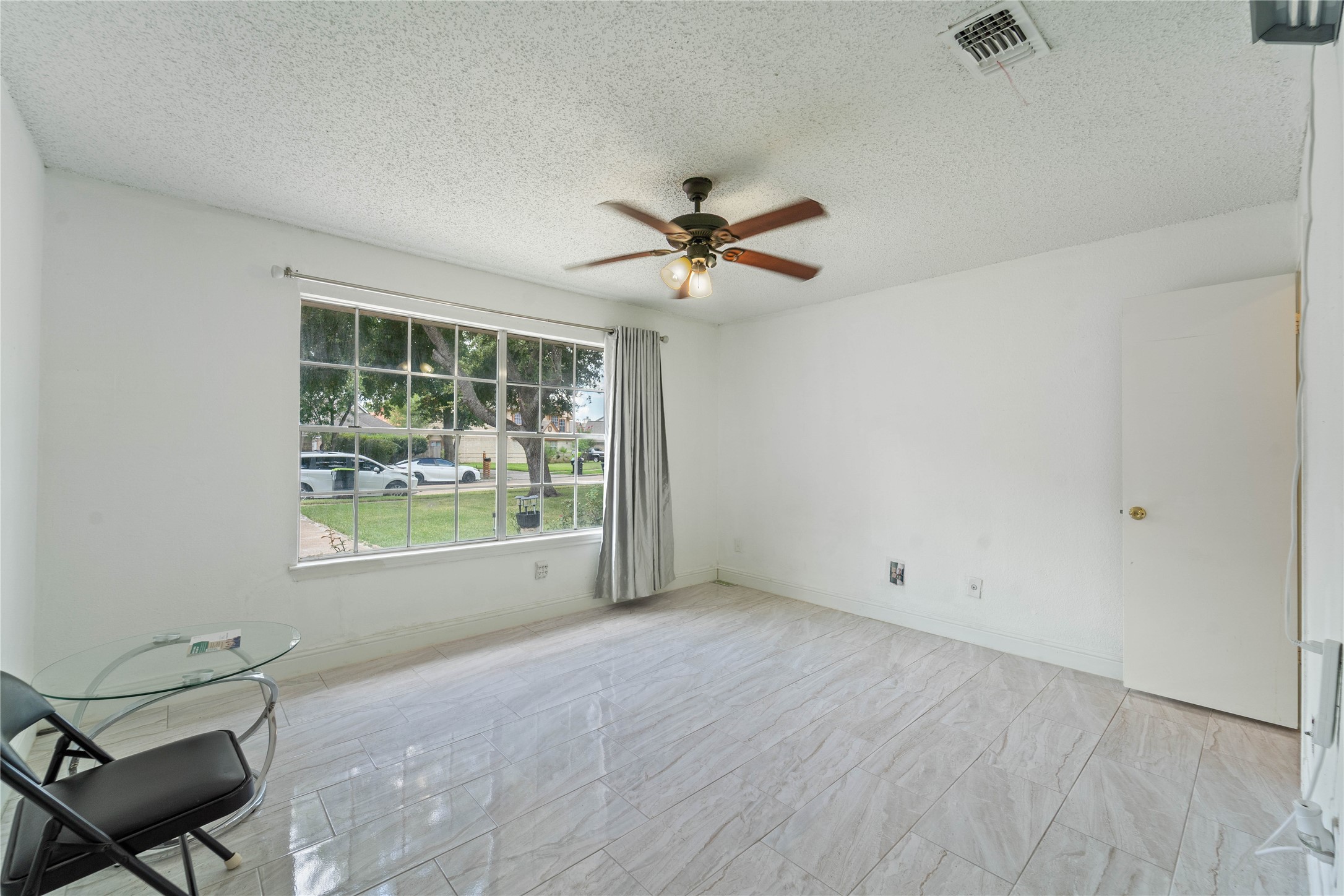 6331 Modesto Drive Houston, TX 77083 - Photo 20 of 31 an empty room with windows and fan