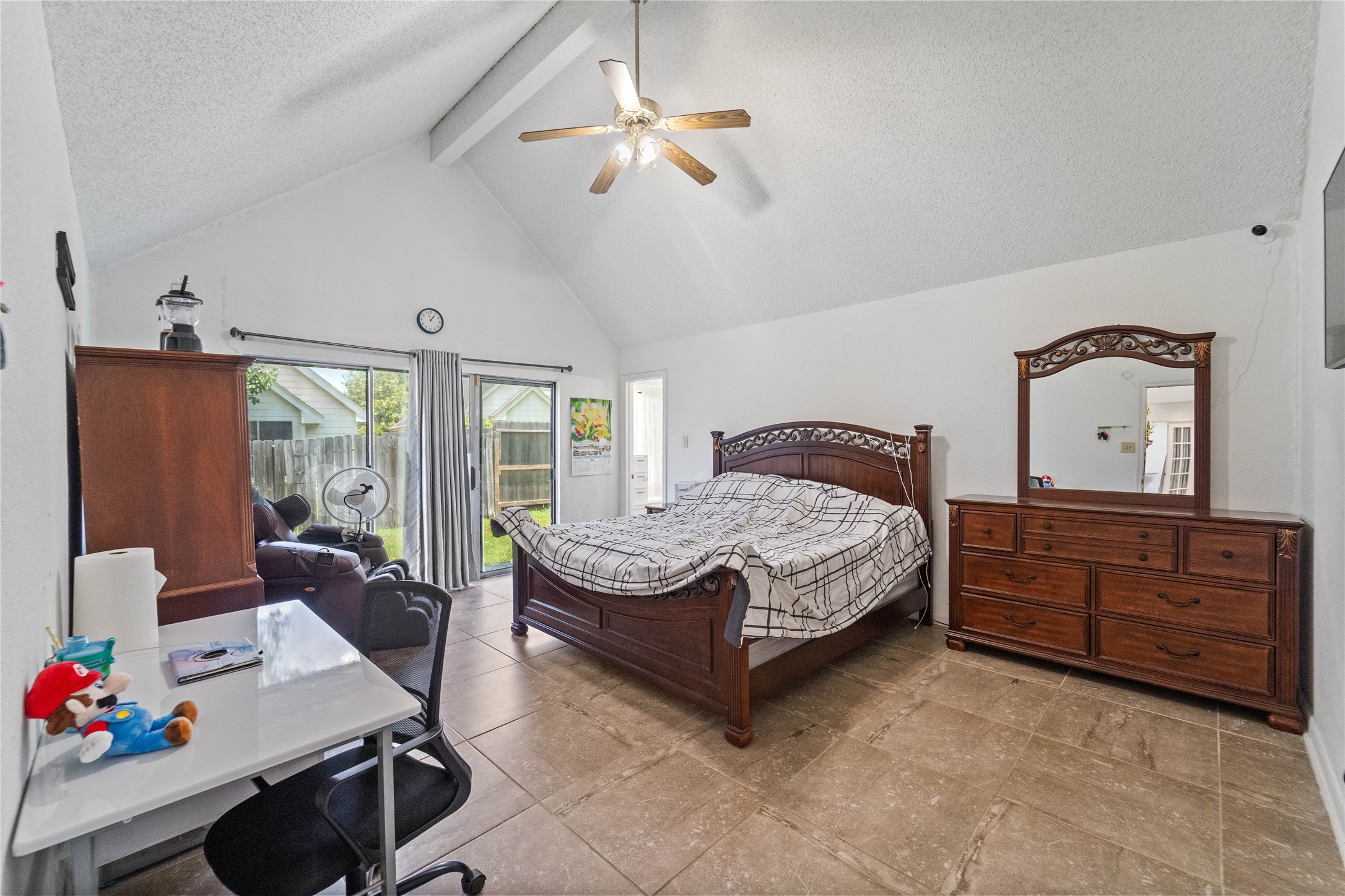6331 Modesto Drive Houston, TX 77083 - Photo 23 of 31 a bedroom with a bed dresser and a window
