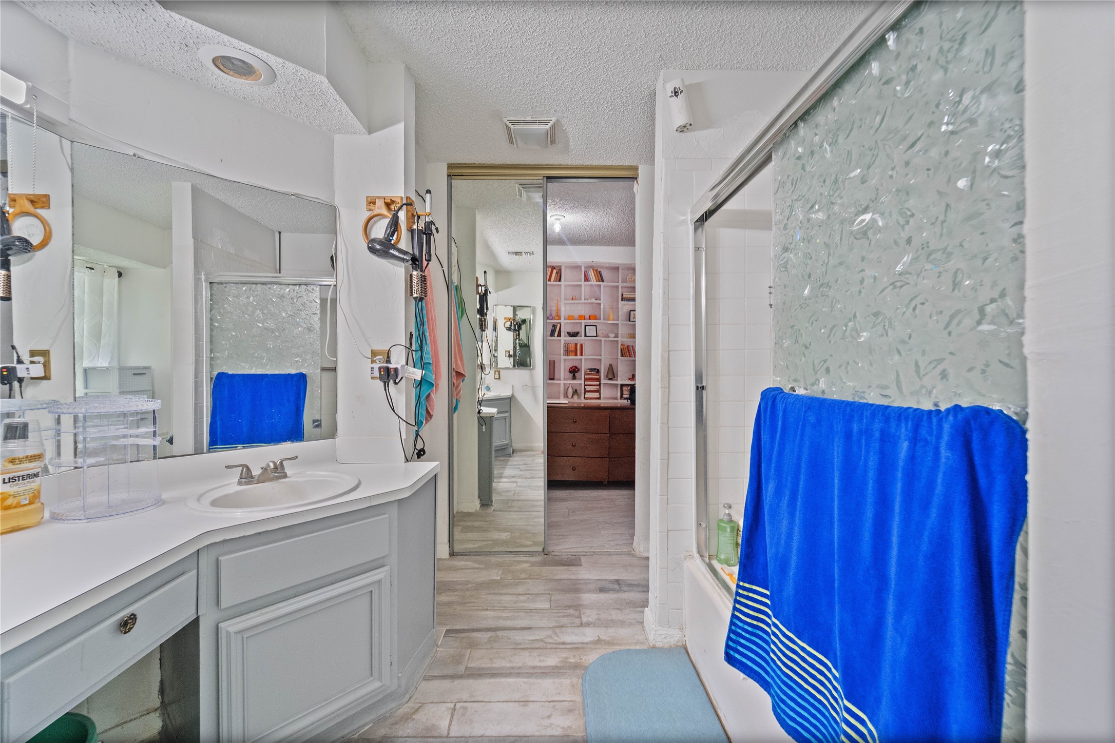 6331 Modesto Drive Houston, TX 77083 - Photo 26 of 31 a bathroom with a sink a mirror and a shower