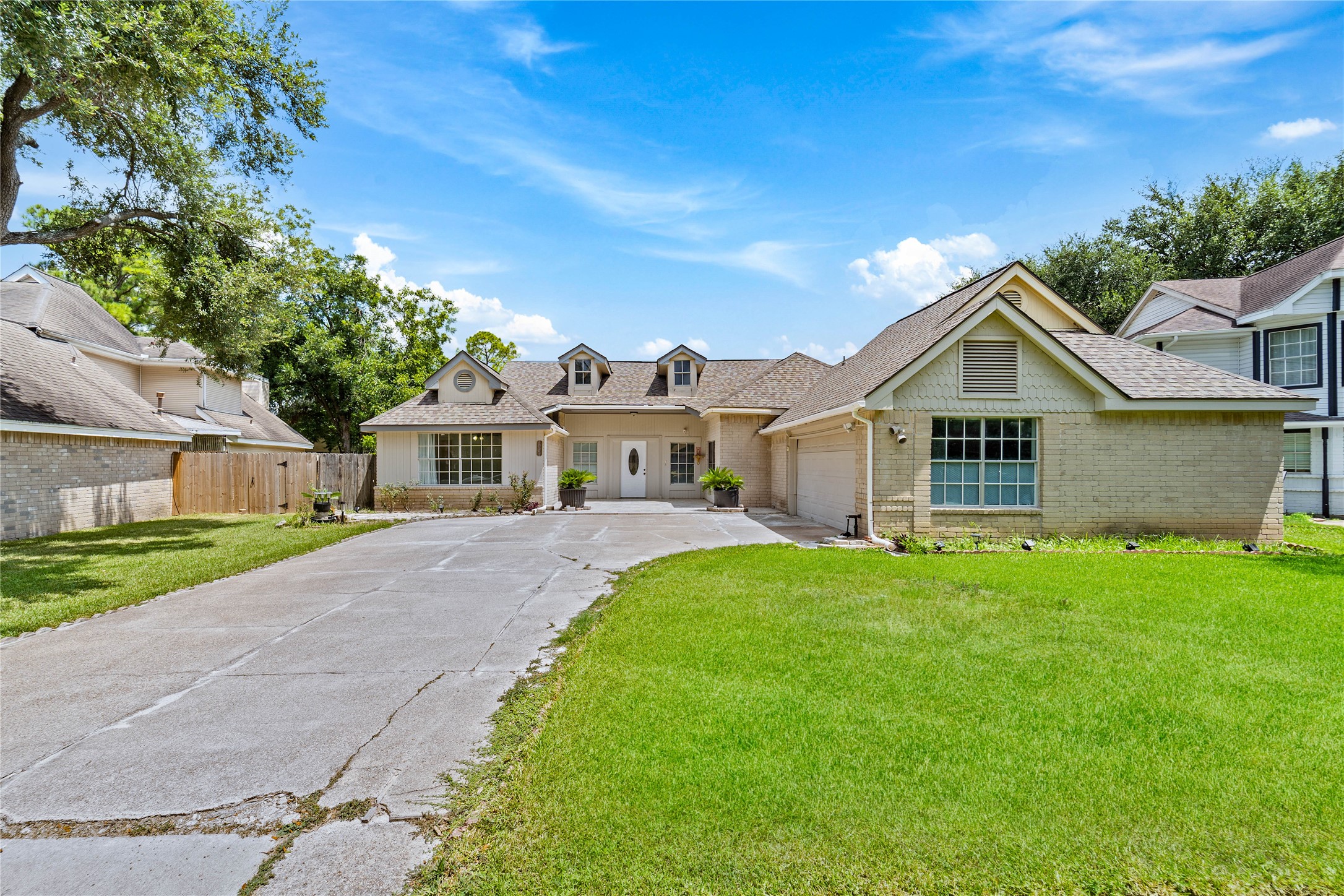 6331 Modesto Drive Houston, TX 77083 - Photo 3 of 31 a front view of a house with a garden