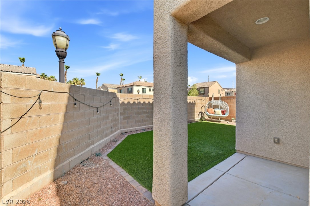 48 Jasmine Point Street Henderson, NV 89074 - Photo 51 of 62 A low-maintenance yard features artificial turf and a covered patio for relaxed outdoor living.
