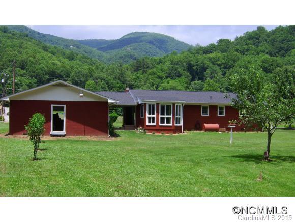 1105 Moody Farm Road Maggie Valley, NC 28751 - Photo 21 of 22 a backyard of a house with table and chairs