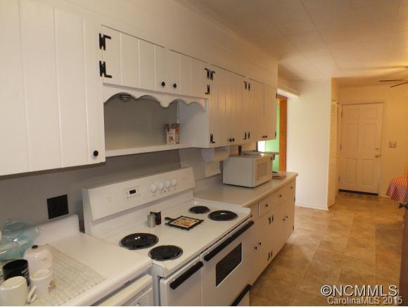 1105 Moody Farm Road Maggie Valley, NC 28751 - Photo 4 of 22 a kitchen with a stove and a refrigerator