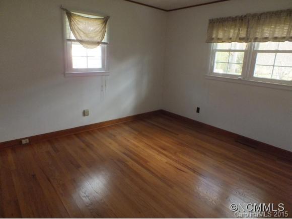1105 Moody Farm Road Maggie Valley, NC 28751 - Photo 8 of 22 an empty room with wooden floor and windows