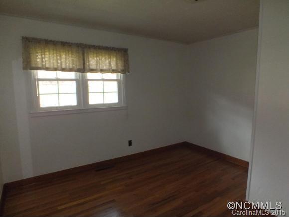 1105 Moody Farm Road Maggie Valley, NC 28751 - Photo 9 of 22 an empty room with wooden floor and windows