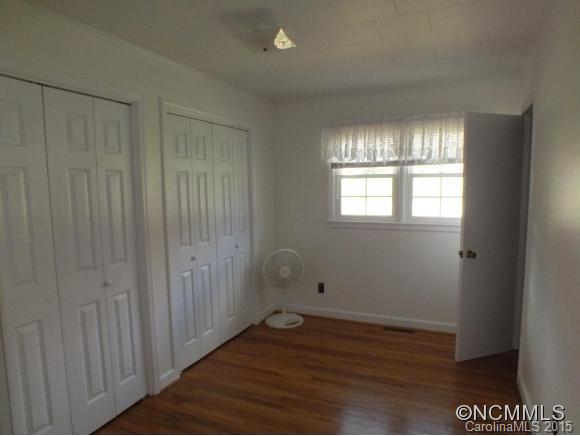1105 Moody Farm Road Maggie Valley, NC 28751 - Photo 10 of 22 a view of an empty room with wooden floor and a window