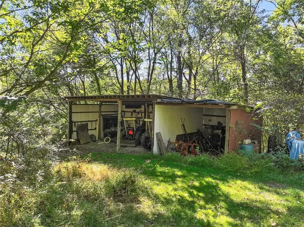 a view of a chair and table in backyard of the house