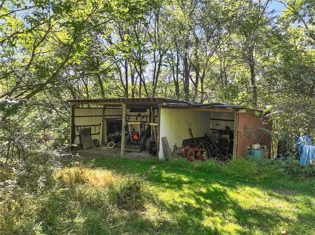 a view of a chair and table in backyard of the house