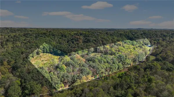 an aerial view of a houses with a yard