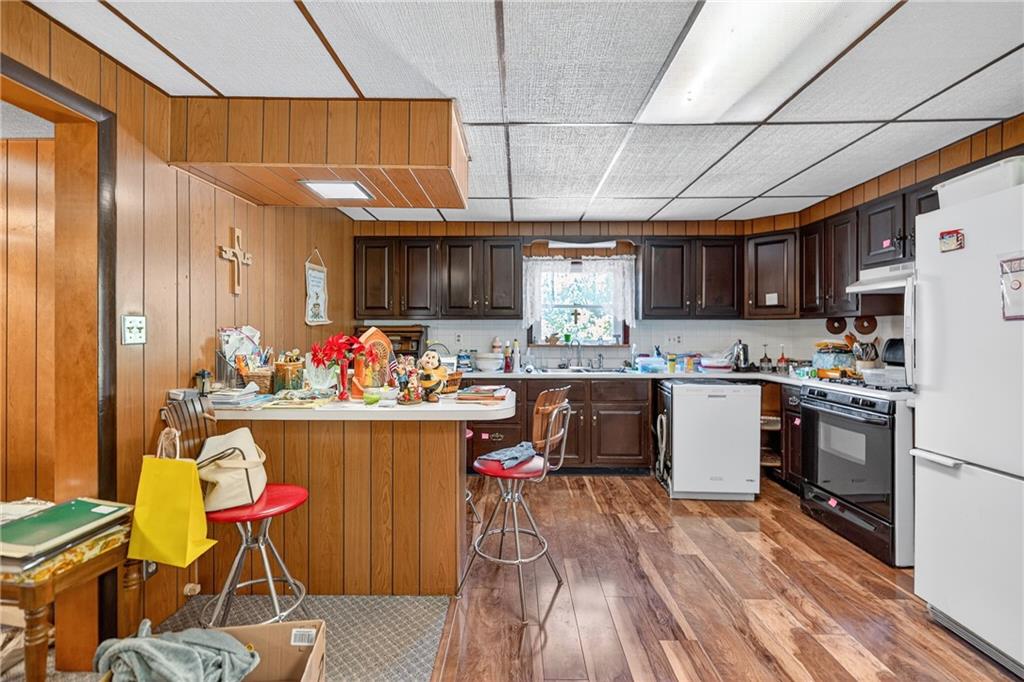 82 Phillips Road Burgettstown, PA 15021 - Photo 38 of 49 a kitchen with stainless steel appliances kitchen island granite countertop a table chairs in it and wooden floors
