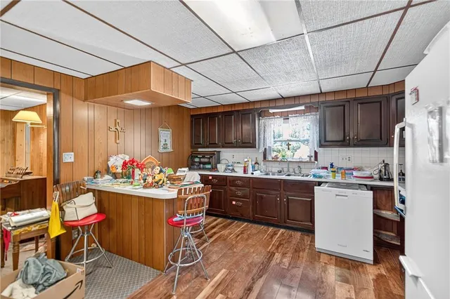a kitchen with sink cabinets and appliances