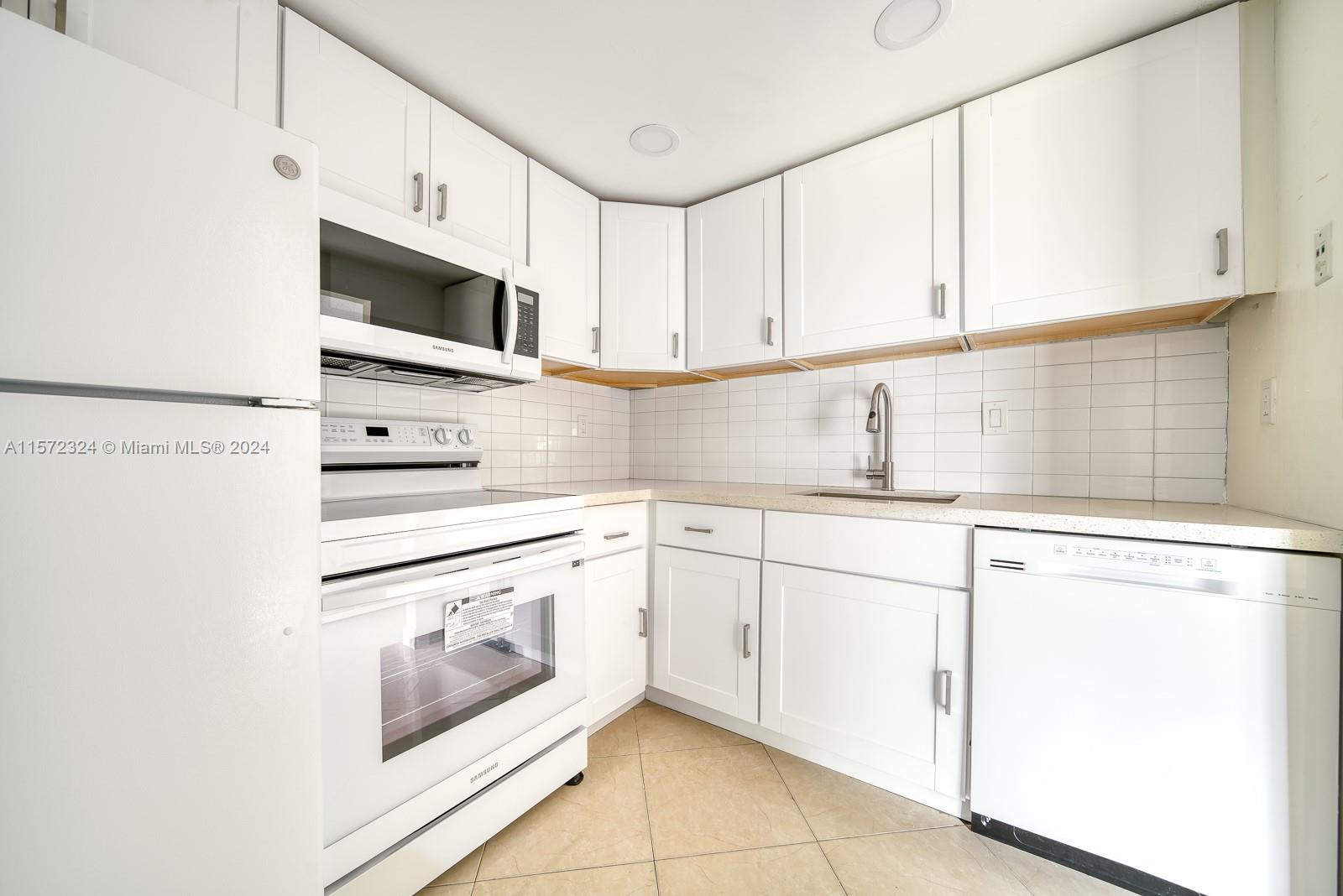 a kitchen with stainless steel appliances white cabinets and a sink
