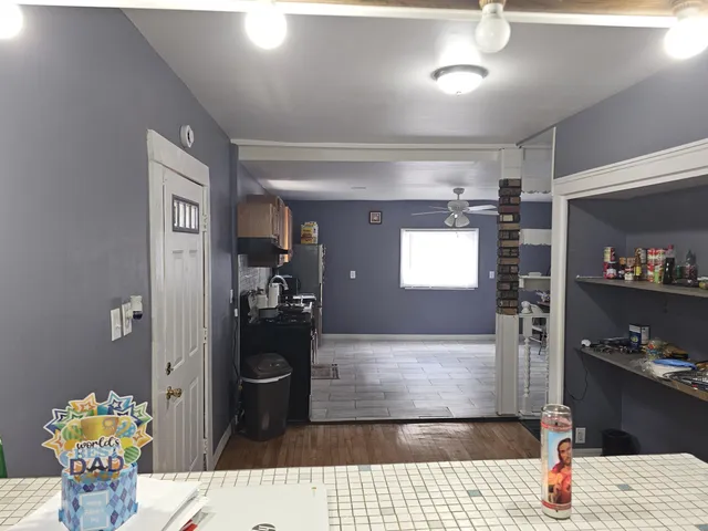 a hallway with dining table and chairs