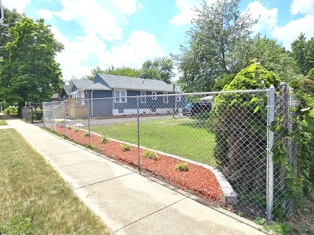 a view of a backyard with a swimming pool