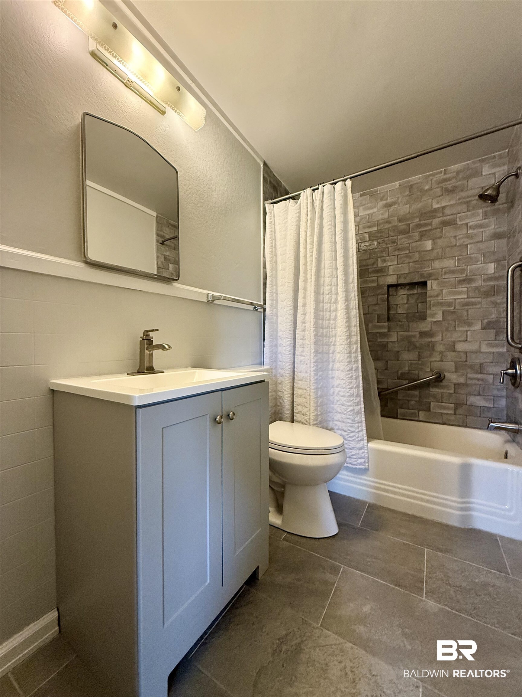 103 Kimberly Street Brewton, AL 36426 - Photo 12 of 18 Bathroom featuring vanity, shower / tub combo, and tile patterned floors