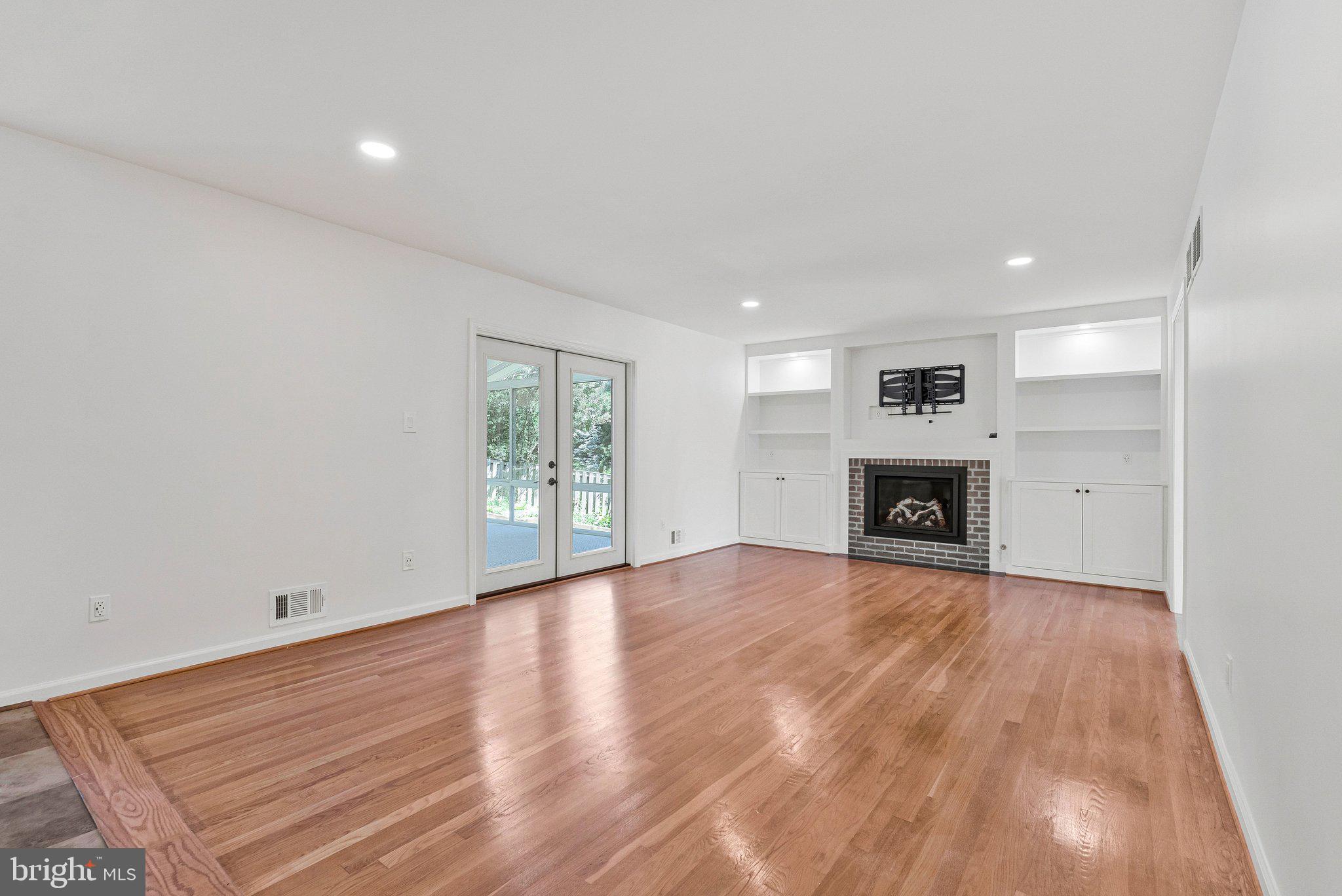 7730 Falstaff Road McLean, VA 22102 - Photo 31 of 83 Family room with gas fireplace and sun room