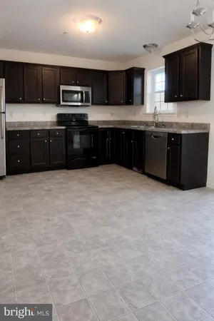 a large kitchen with stainless steel appliances granite countertop a stove granite counter tops and cabinets