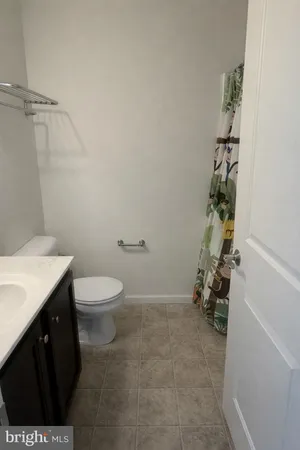 a bathroom with a toilet a sink and tub
