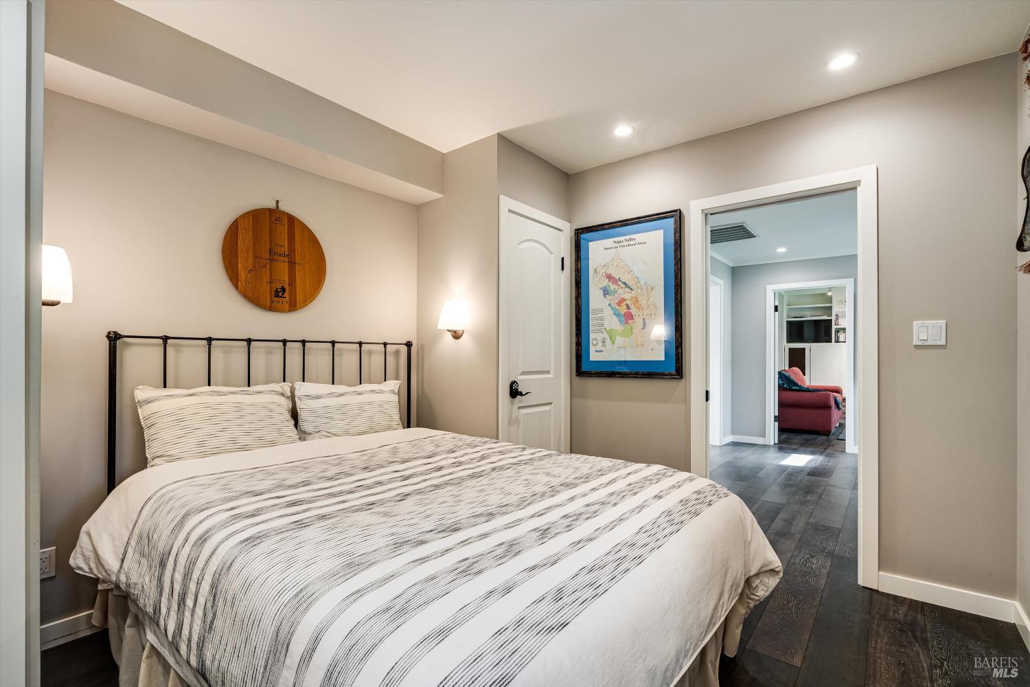 850 Conn Valley Road St. Helena, CA 94574 - Photo 16 of 79 a bedroom with a large bed and a chandelier