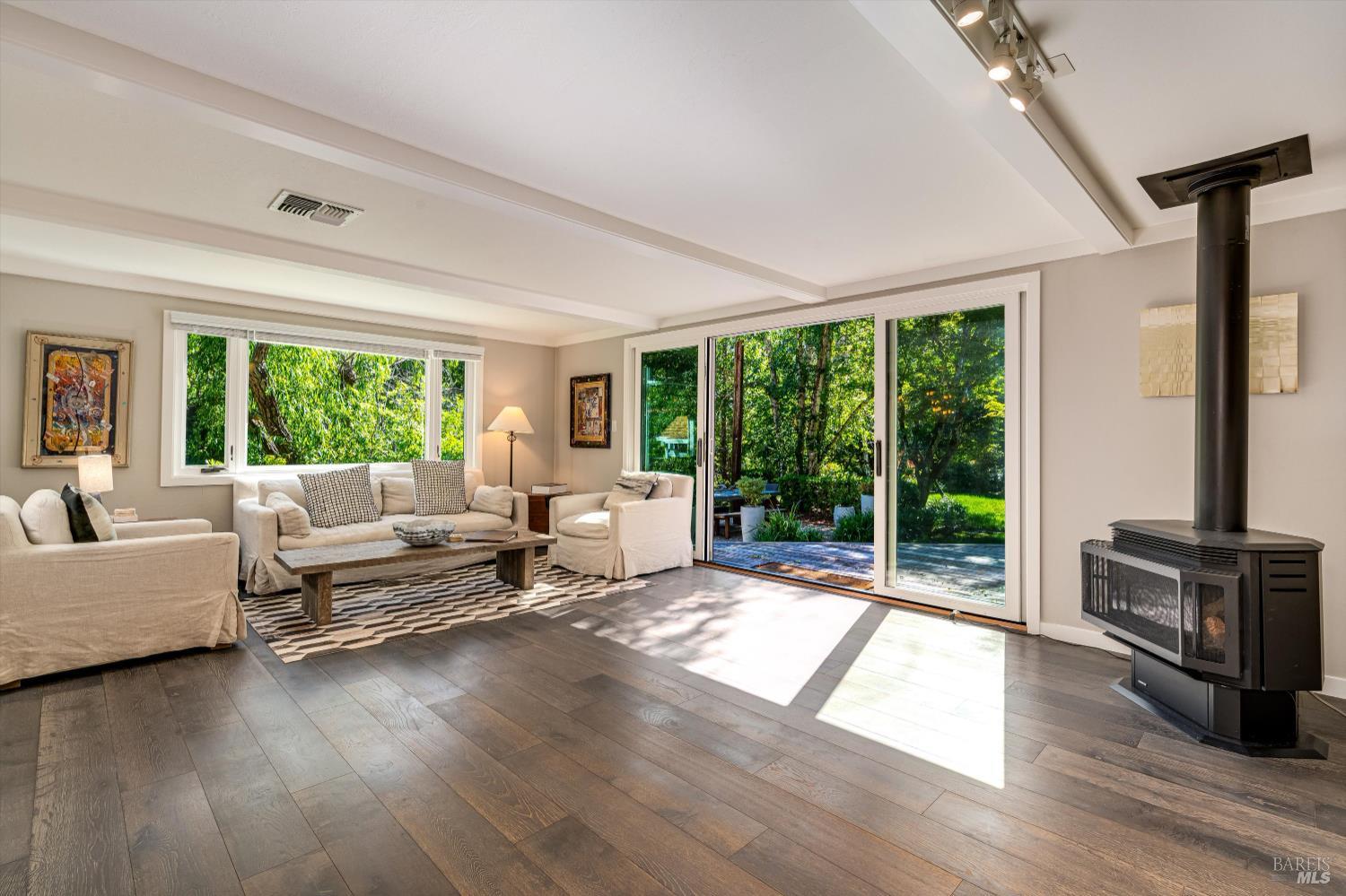 850 Conn Valley Road St. Helena, CA 94574 - Photo 18 of 79 a living room with furniture large windows and wooden floor