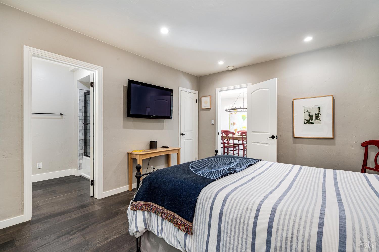 850 Conn Valley Road St. Helena, CA 94574 - Photo 20 of 79 a bedroom with a bed and a flat screen tv