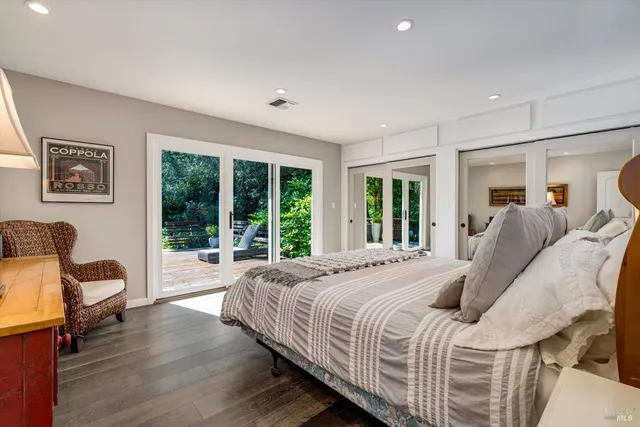 a bedroom with a large bed and a large window