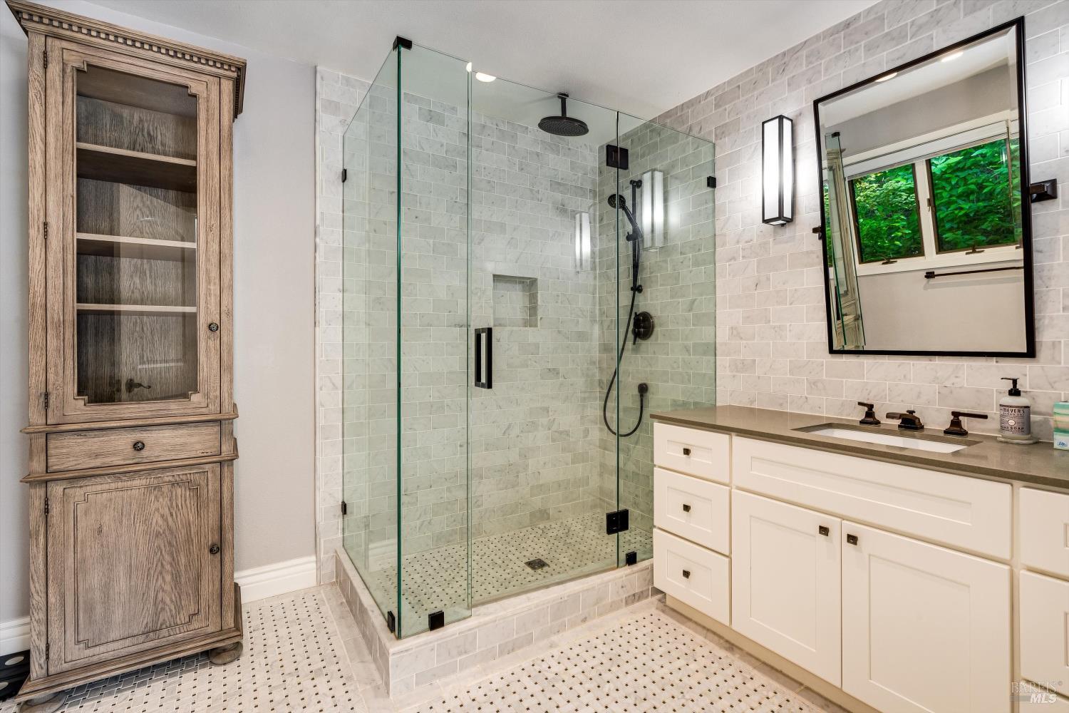 850 Conn Valley Road St. Helena, CA 94574 - Photo 27 of 79 a bathroom with a shower sink and mirror