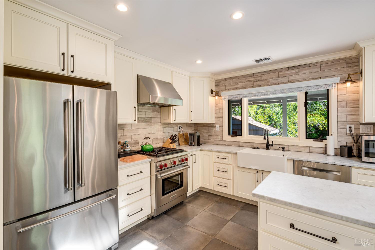850 Conn Valley Road St. Helena, CA 94574 - Photo 37 of 79 a kitchen with white cabinets and white appliances