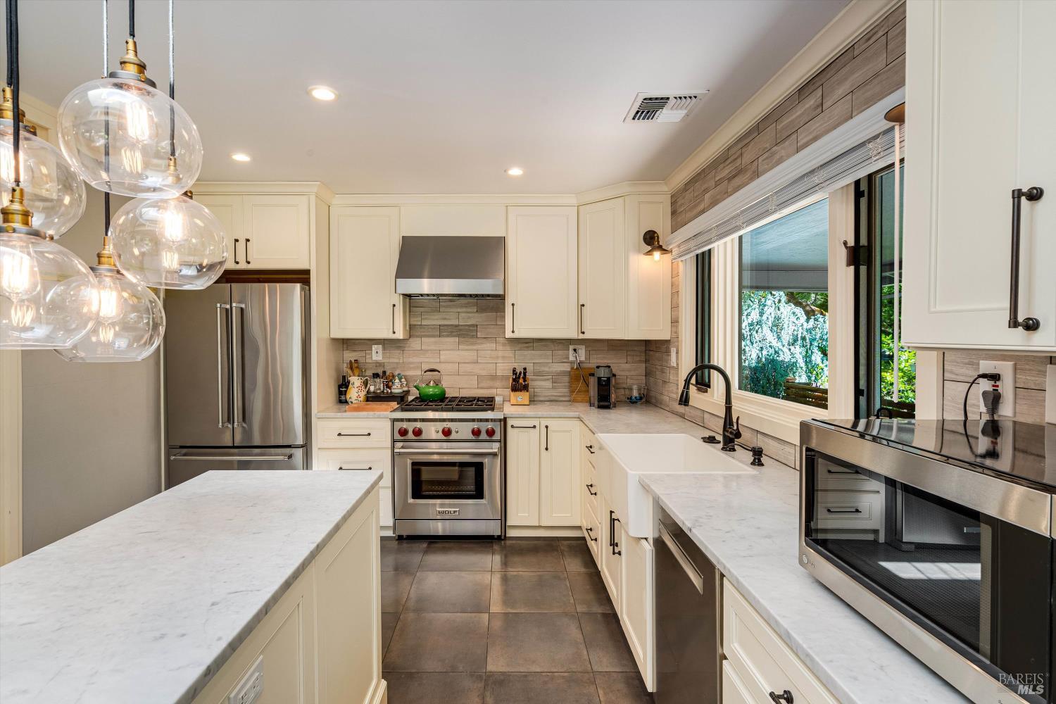 850 Conn Valley Road St. Helena, CA 94574 - Photo 39 of 79 a kitchen with kitchen island granite countertop a sink cabinets stainless steel appliances and a counter top