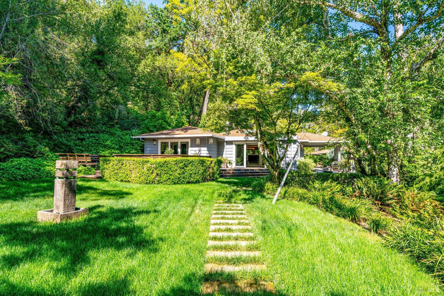 850 Conn Valley Road St. Helena, CA 94574 - Photo 58 of 79 a front view of a house with a yard table and chairs