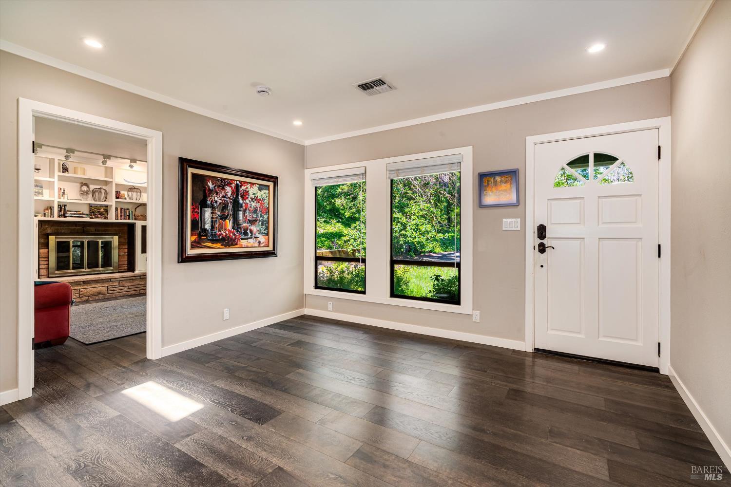 850 Conn Valley Road St. Helena, CA 94574 - Photo 6 of 79 a view of an empty room with a window and wooden floor
