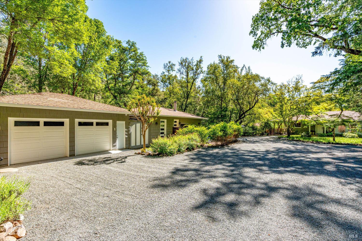 850 Conn Valley Road St. Helena, CA 94574 - Photo 65 of 79 a front view of a house with a yard and garage