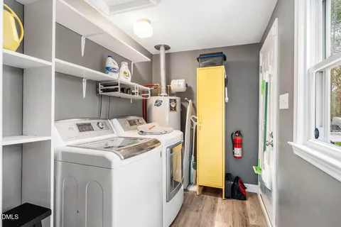 a view of a backyard with table and chairs under an umbrella