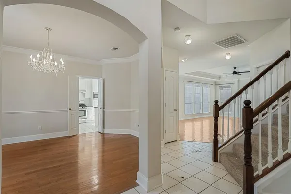 a view of a hallway with wooden floor and staircase
