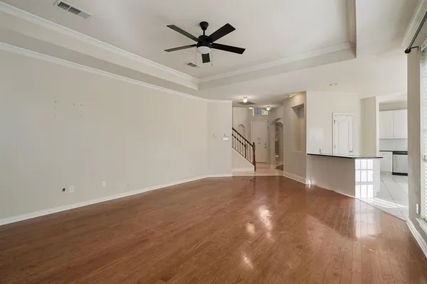 a view of an empty room and wooden floor