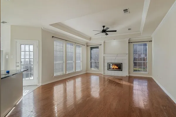 a view of an empty room with a fireplace and a window