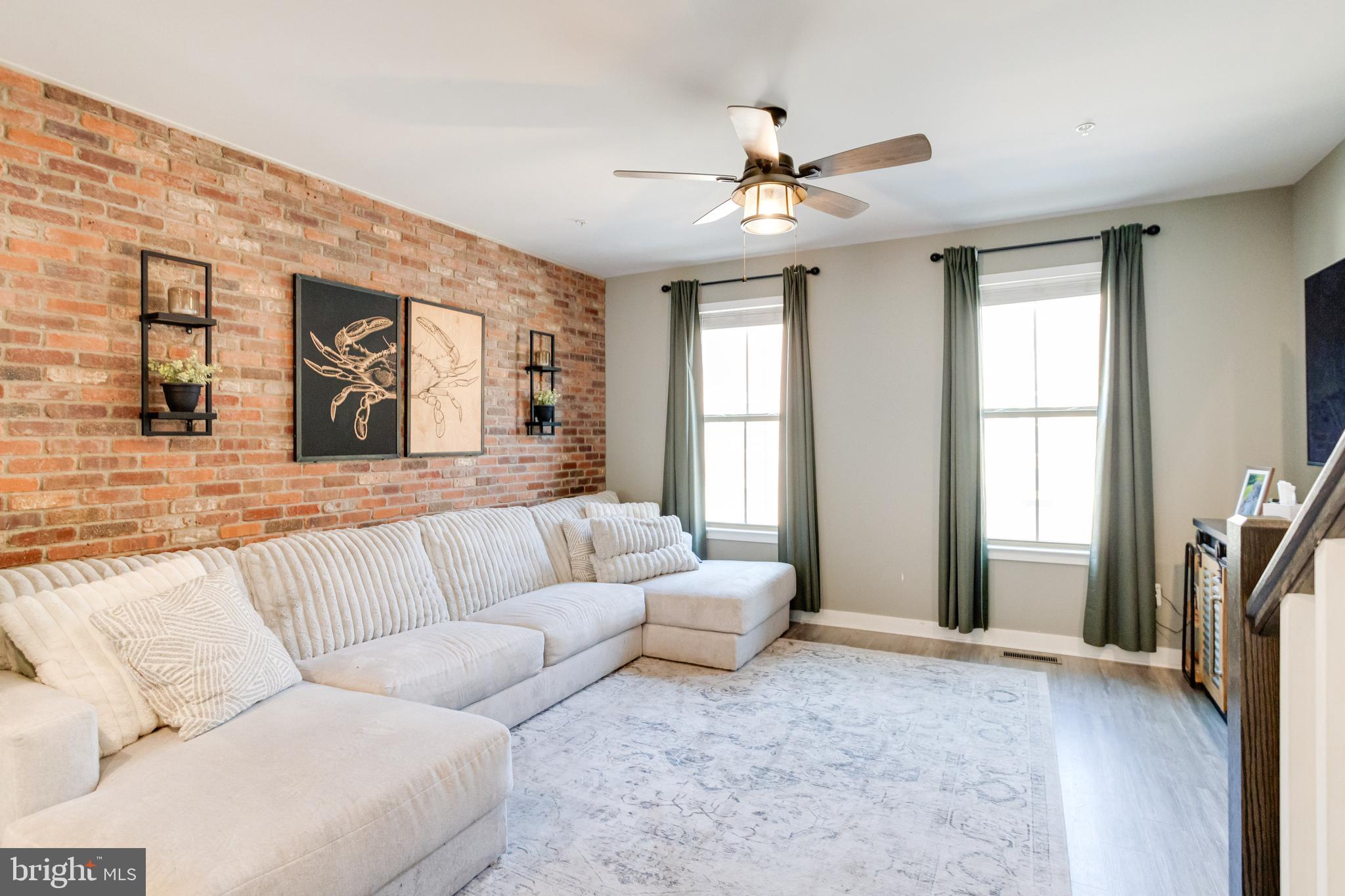 216 South Newkirk Street Baltimore, MD 21224 - Photo 13 of 35 Family Room with Exposed Brick Wall