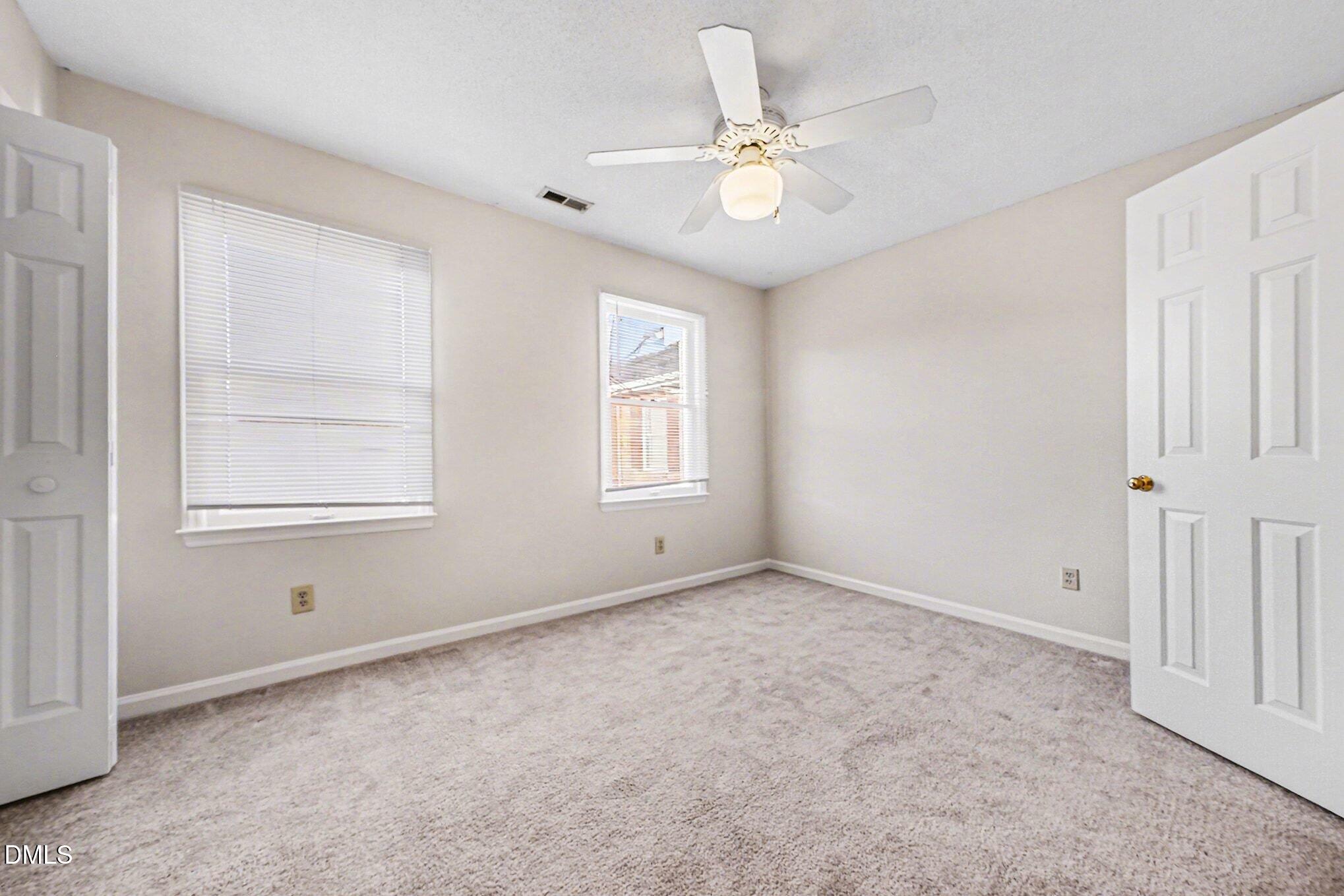 1509 Clermont Road, Unit T27 Durham, NC 27713 - Photo 16 of 26 an empty room with windows and fan