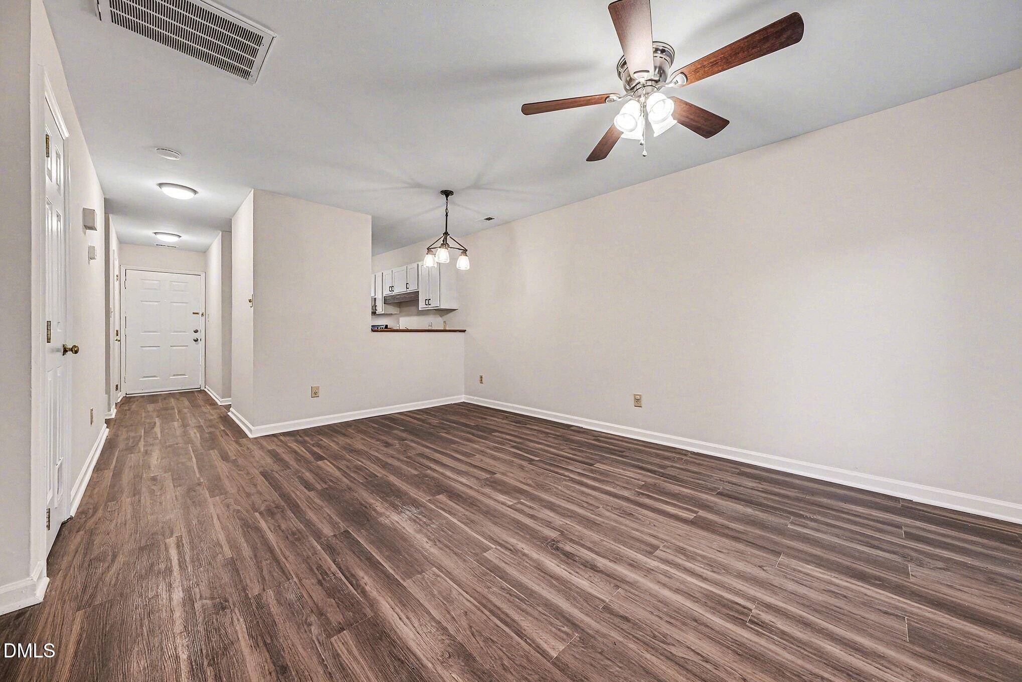 1509 Clermont Road, Unit T27 Durham, NC 27713 - Photo 4 of 26 wooden floor in an empty room with a chandelier fan