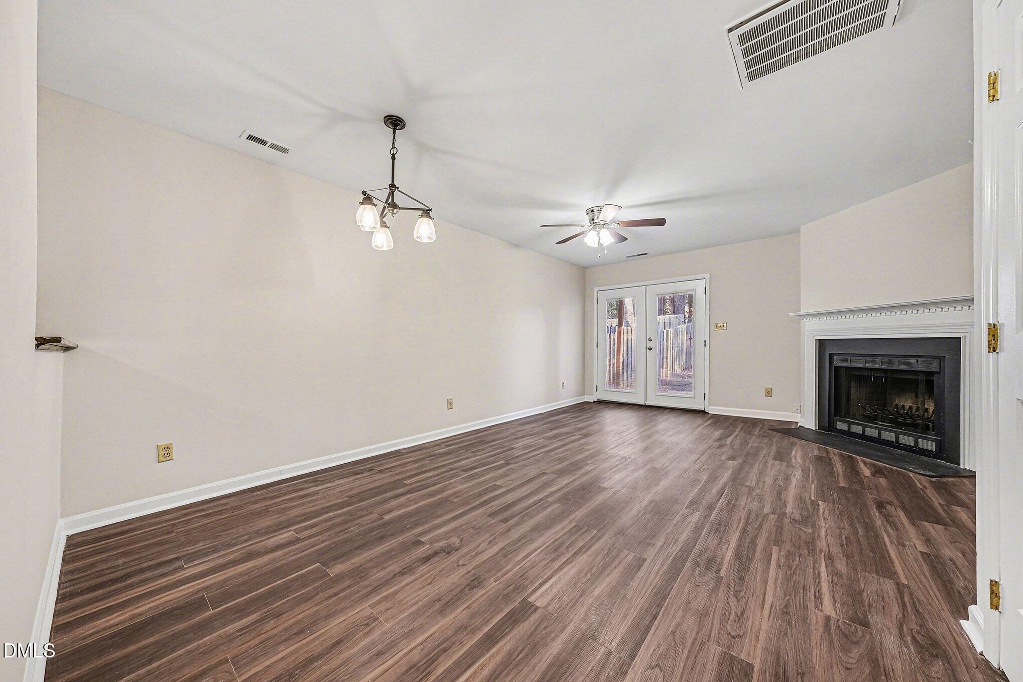 1509 Clermont Road, Unit T27 Durham, NC 27713 - Photo 5 of 26 wooden floor in an empty room with a fireplace