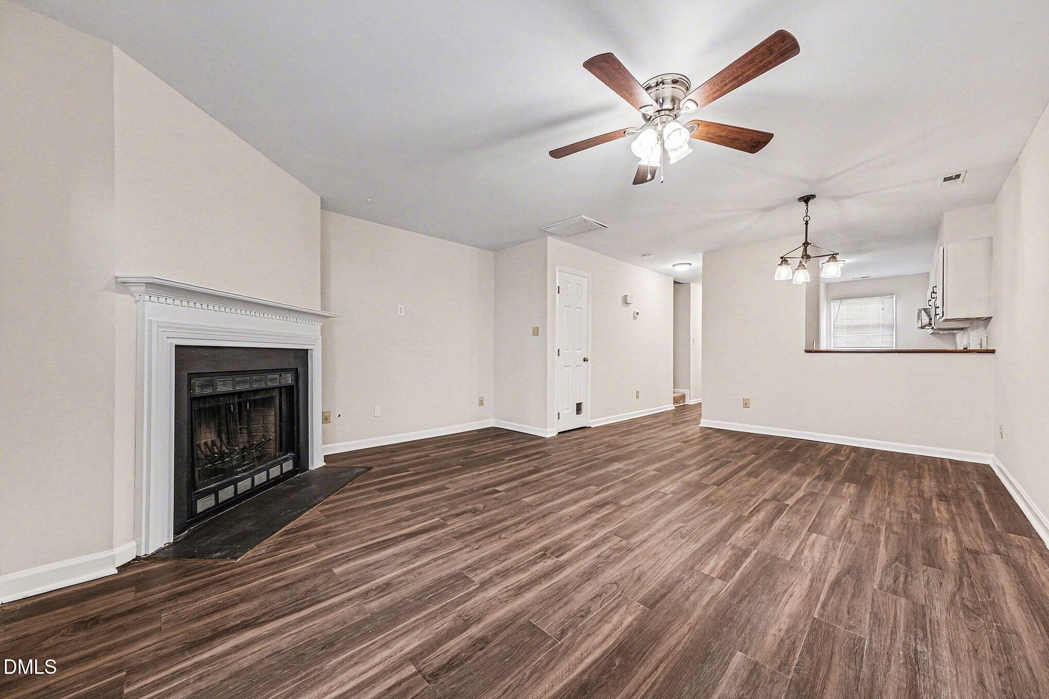 1509 Clermont Road, Unit T27 Durham, NC 27713 - Photo 7 of 26 an empty room with fan and a fireplace