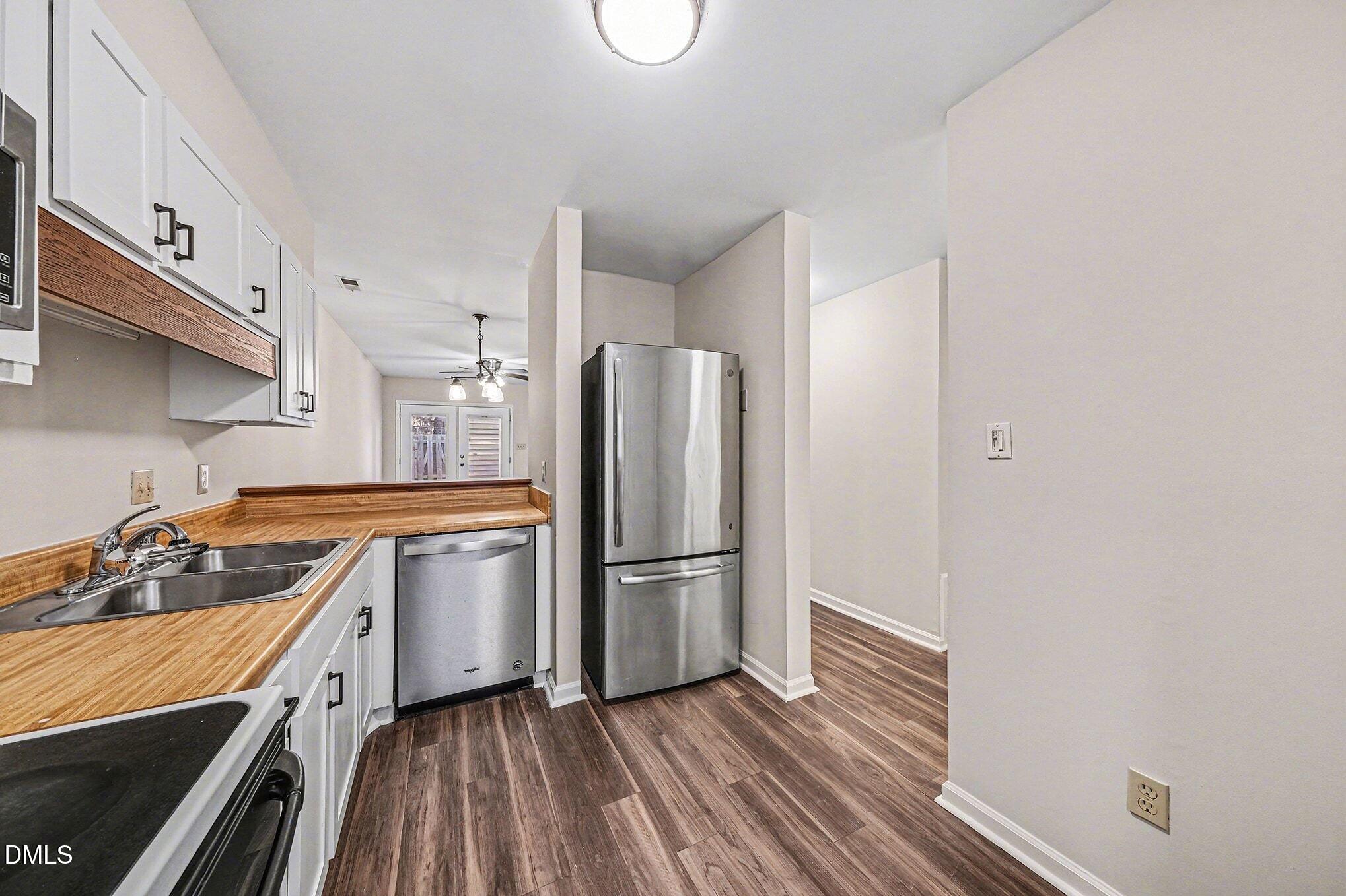 1509 Clermont Road, Unit T27 Durham, NC 27713 - Photo 9 of 26 a kitchen with wooden floor and a stove