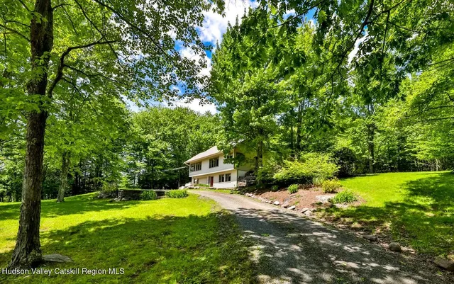a view of a house with a yard