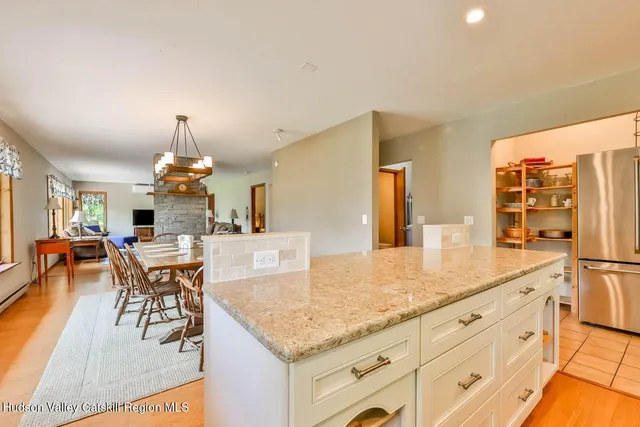 a view of a kitchen counter top space with furniture and wooden floor