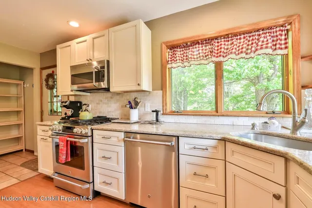 a kitchen with appliances cabinets and a sink
